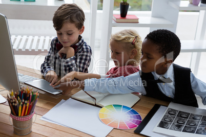 Business people discussing over digital tablet in creative office