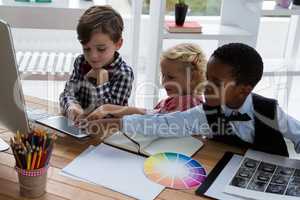 Business people discussing over digital tablet in creative office