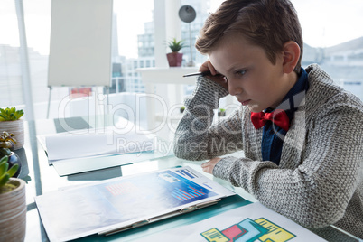 Close up of businessman reading documents while sitting at desk