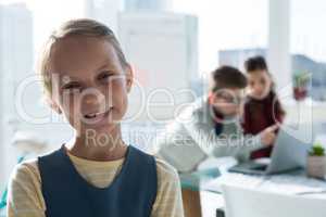 Portrait of businesswoman with coworkers working in background