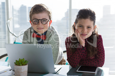 Portrait of smiling business people standing at table