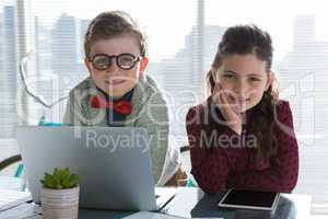 Portrait of smiling business people standing at table