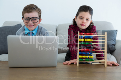 Portrait of business people working while sitting on sofa in office