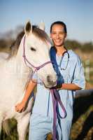 Portrait smiling female vet by horse