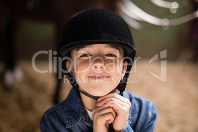 Portrait of smiling girl fastening helmet