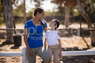 Smiling jockey talking with sister