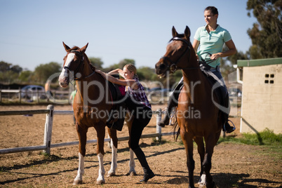 Female friends preparing for horse background