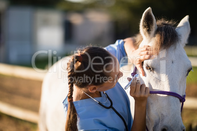 Close up of female vet examining horse eye
