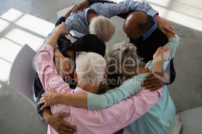 High angle view of senior friends huddling