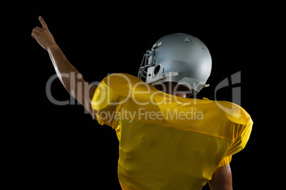 American football player pointing upwards