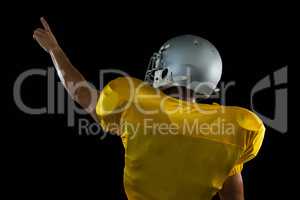 American football player pointing upwards