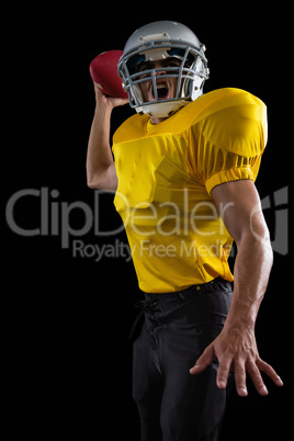 Energetic American football player holding a ball in one hand