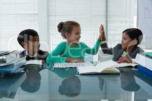 Happy business people working in boardroom