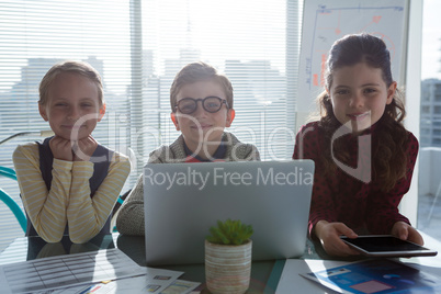 Portrait of confident business people standing at table