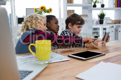 Business people discussing over tablet in office