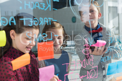 Business people analyzing data on window seen through glass