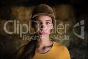 Portrait of serious female jockey in stable