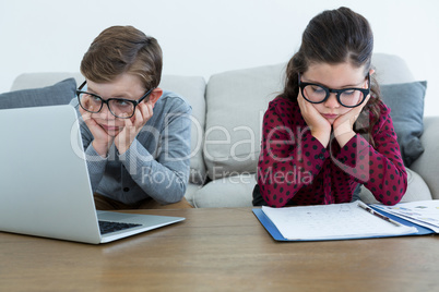 Business people working while sitting on sofa in office