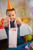 Girl holding a gift bag during birthday party