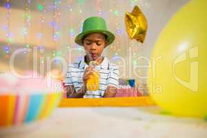 Boy drinking juice during birthday party