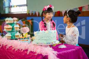 Friends interacting with each other during birthday party