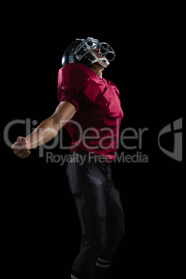 American football player posing with arms stretched open
