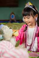 Girl playing with soft toy during birthday party