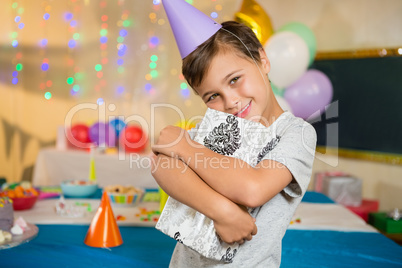 Boy embracing gift box during birthday party at home