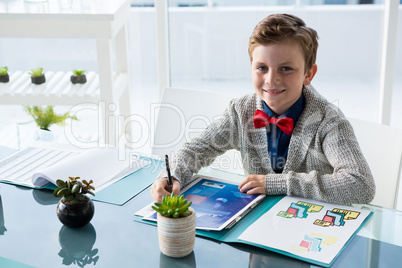 High angle portrait of businessman reading documents while sitting at desk