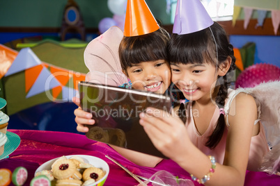Kids using digital tablet during birthday party