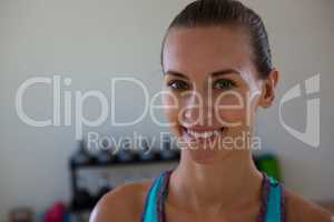 Portrait of smiling female athlete in gym