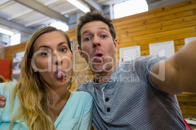 Portrait of couple making faces in cafe
