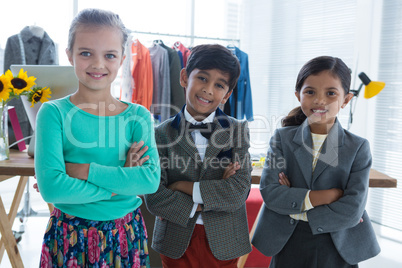 Portrait of business people with arms crossed standing in office