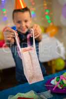 Girl holding a gift bag during birthday party