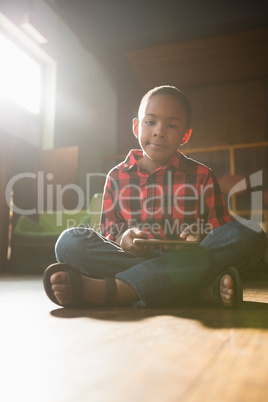 Portrait of cute boy using digital tablet