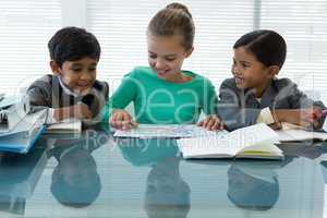 Smiling kids discussing in boardroom