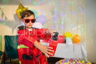 Cute boy pretending to be a fireman during birthday party