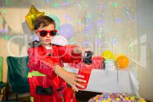 Cute boy pretending to be a fireman during birthday party