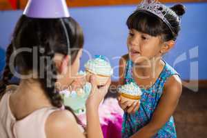 Kids having cupcake during birthday party
