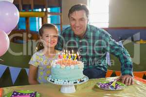 Father and daughter celebrating birthday at home