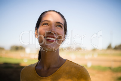 Happy thoughtful female jockey looking up