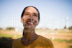 Happy thoughtful female jockey looking up