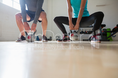 Low section of athletes lifting kettlebells