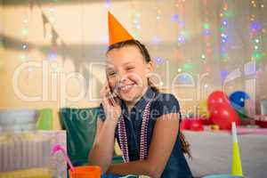 Girl talking on mobile phone during birthday party