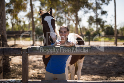 Portrait of smiling jockey with horse