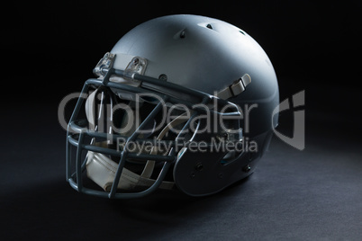 American football head gear on a black background