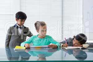 Businessman looking at businesswomen working in boardroom