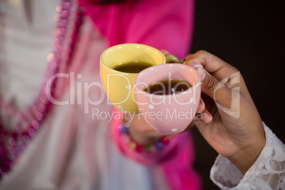 Friends having coffee during birthday party at home