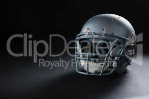 American football head gear on a black background