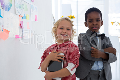 Portrait of smiling business people standing by whiteboard in office